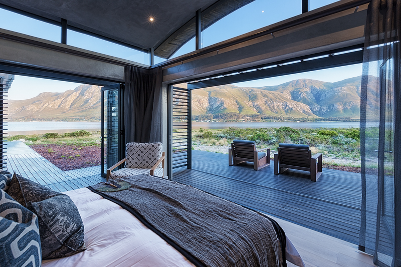 <p>BEDROOMS<br /> &ndash; Individually furnished rooms with views overlooking mountains, lagoon and Fynbos<br /> &ndash; Large foldaway doors that lead to private terraces with unobstructed Lagoon and mountain views<br /> &ndash; King size extra length beds which can be a turned into singles on request<br /> &ndash; En-suite bathrooms, bath &amp; shower with underfloor heating<br /> &ndash; Eco pellet stoves<br /> &ndash; Ceiling fans<br /> &ndash; All rooms have a writing desk and Wi-Fi access points</p>