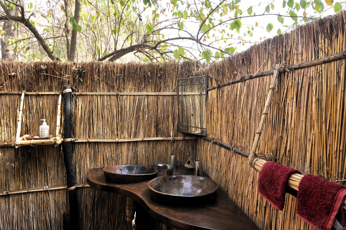 <p>basins and mirror with reed screen</p>