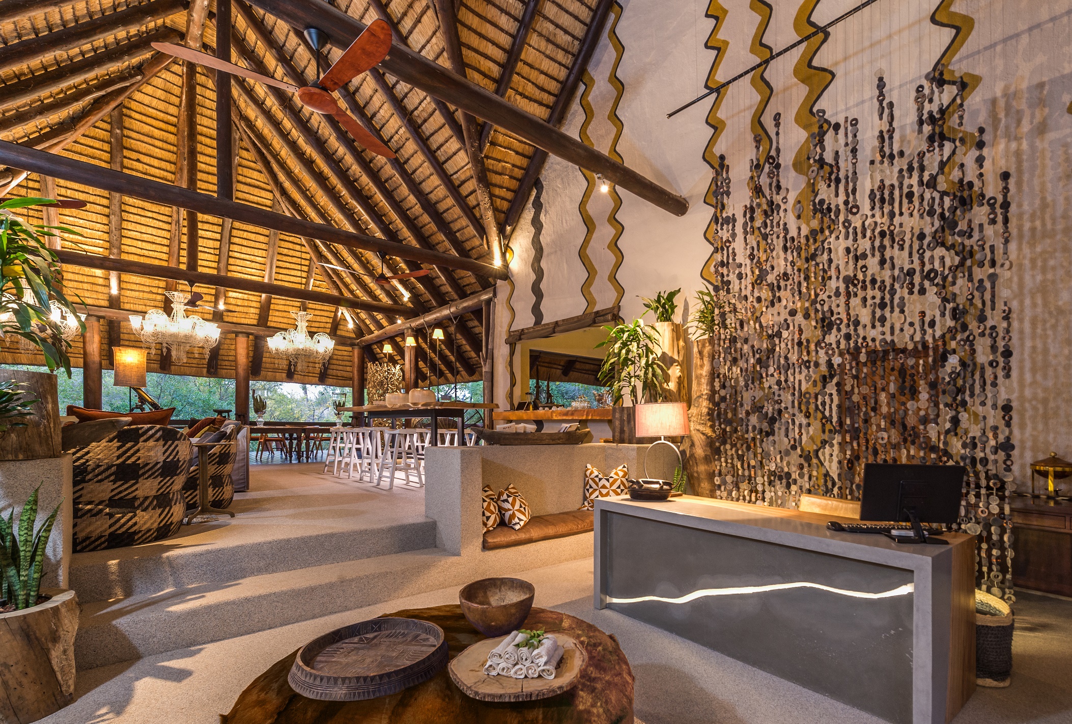 <p>The reception area is an open-air space that features high thatched ceilings, natural materials such as wood and stone, and African-inspired decor. The space is beautifully decorated with comfortable seating areas, local artwork, and a range of charming accents that create a warm and inviting atmosphere.</p>